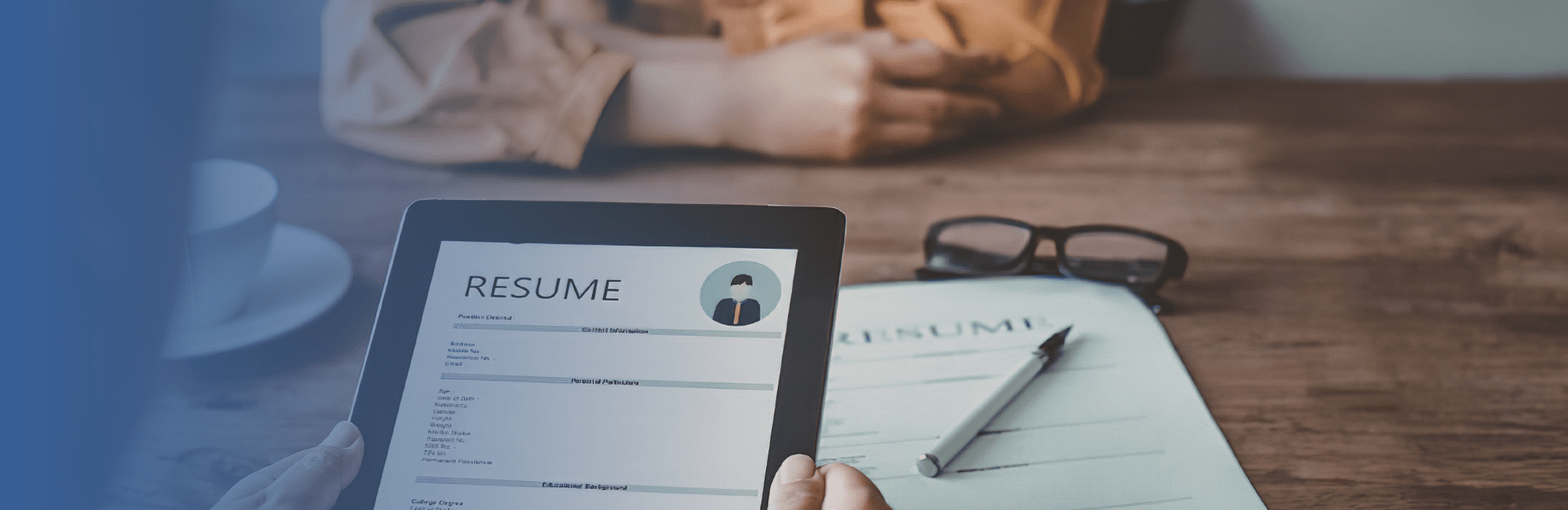 Digital resume being reviewed on a tablet during a job interview.